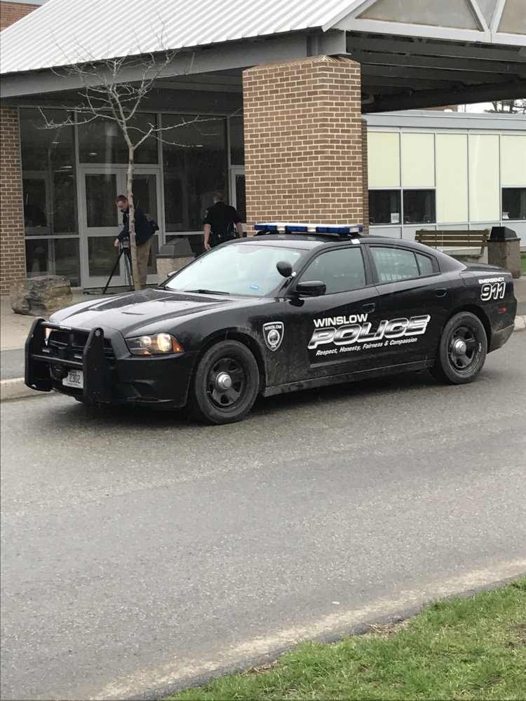 A Winslow Police cruiser is parked outside the high school Friday morning after area schools went into lockout mode as authorities searched for a burglary suspect in the area.