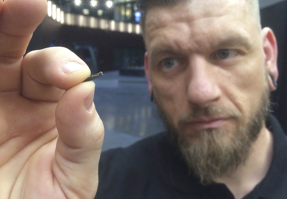 Self-described “body hacker” Jowan Osterlund from Biohax Sweden holds a microchip implant similar to those implanted into workers at the Epicenter digital innovation business center.