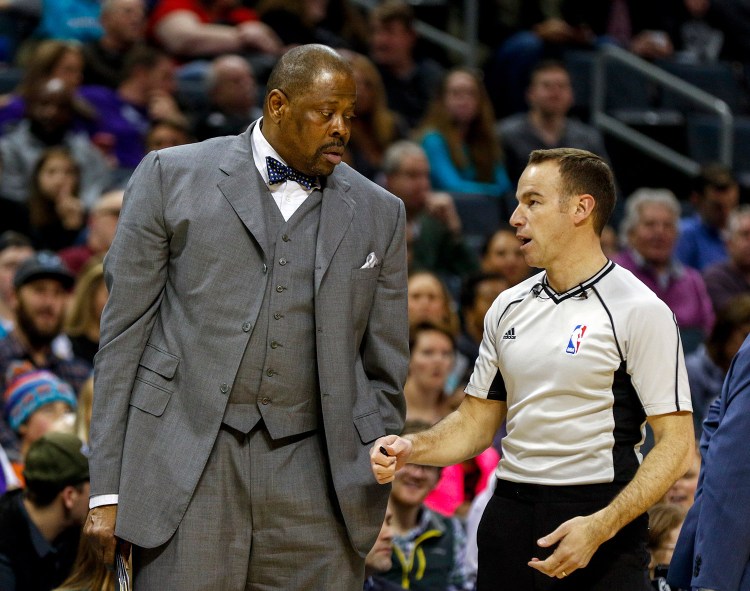 Charlotte Hornets assistant coach Patrick Ewing, left, talks to NBA referee Josh Tiven during the Jan. 28 Hornets NBA game against the Sacramento Kings. Ewing has been hired as Georgetown's men's basketball coach, more than two decades after he led the Hoyas to their only national championship.  