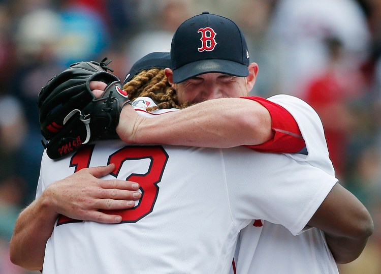 Boston Red Sox's Hanley Ramirez hugs Craig Kimbrel after the Red Sox defeated the Tampa Bay Rays 4-3 in a baseball game Monday in Boston.