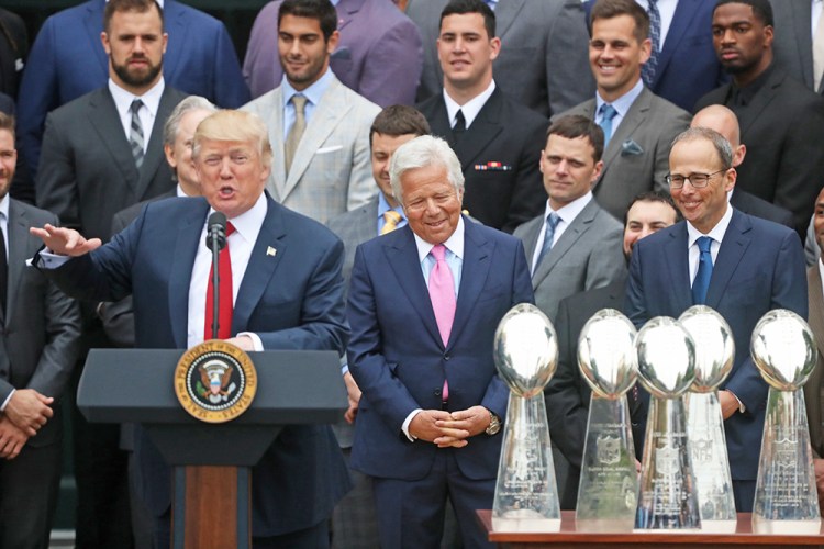 New England Patriots owner Robert Kraft, center, and team members listen as President Trump speaks during a ceremony on the South Lawn of the White House in April.