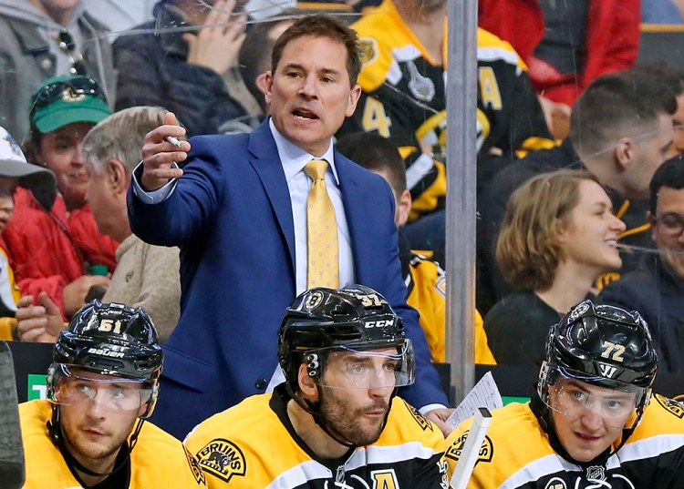 Boston Bruins coach Bruce Cassidy works behind the bench in the third period of a game against the Washington Capitals on April 8, 2017. Cassidy has helped the team return to the playoffs for the first time in three seasons. 