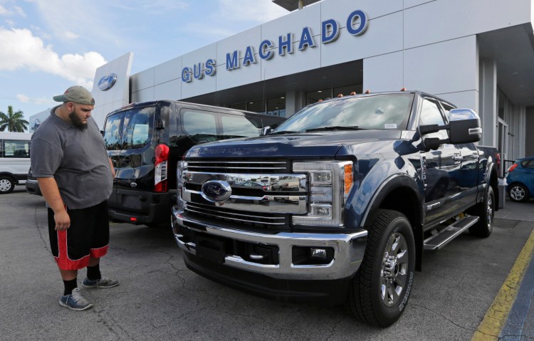 A potential customer looks at a 2017 Ford F-250 Lariat at a dealership in Hialeah, Fla., on Jan. 17.