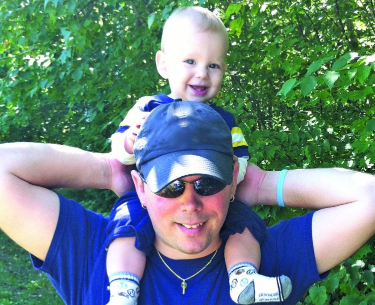 Jake Roberts, shown with his son, Luc, is a “master coach” in the Maine Boys To Men “boot camp” for new dads.