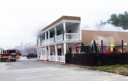 Firefighters work to extinguish a fire at A La Mexicana restaurant in Raymond on Wednesday.