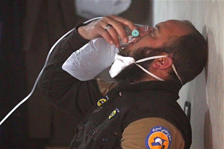 A Syrian civil defense member breathes through an oxygen mask after what rescue workers say was a gas attack in the town of Khan Sheikhoun in rebel-held Idlib. 