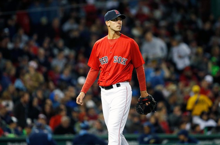 Boston's Rick Porcello walks off the field after being taken out during the fifth inning of Friday night's game at Fenway Park.