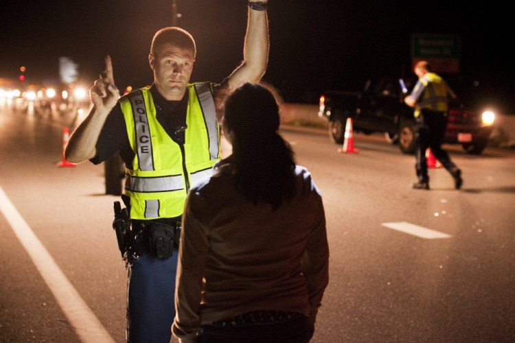 Police conduct field sobriety tests in 2013 in Cumberland County. About 350 people have been convicted of operating under the influence nine or more times in Maine; more than 16,000 have at least four OUI convictions.