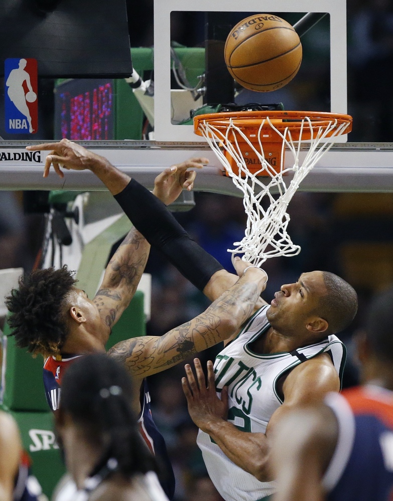 Boston Celtics' Al Horford, right, blocks a shot by Washington Wizards' Kelly Oubre Jr., left, during the second quarter of a second-round NBA playoff series basketball game, Sunday, April, 30, 2017, in Boston. (AP Photo/Michael Dwyer)