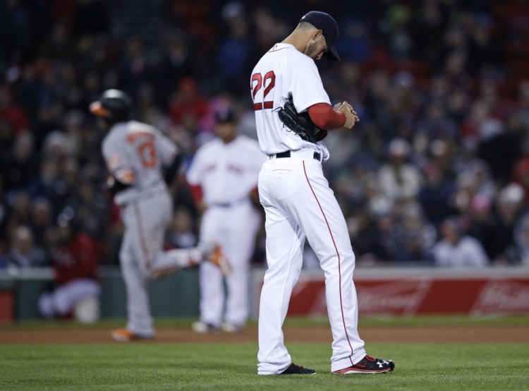Boston Red Sox starter Rick Porcello stands near the mound as the Orioles' Manny Machado rounds the bases after hitting a solo home run in the sixth inning Monday night in Boston. Porcello fell to 1-4 with the loss.