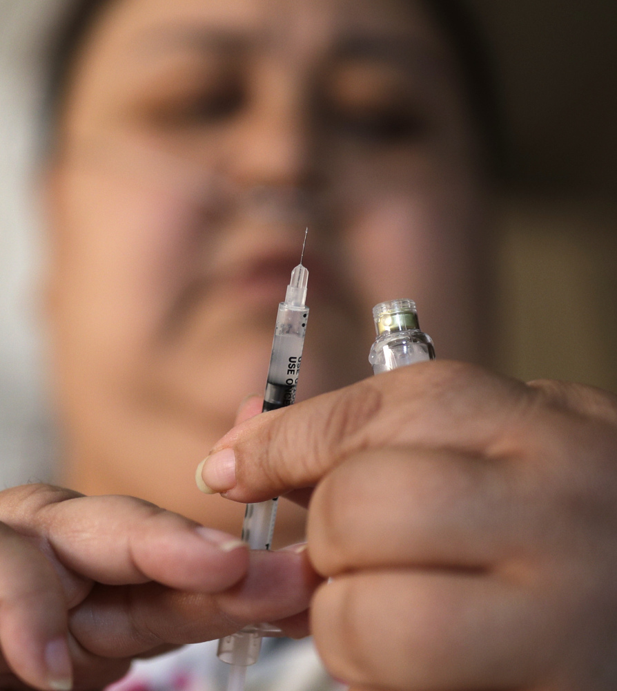 Soila Solano prepares to inject herself with insulin last month at her home in Las Vegas, where a bill to control medical insurance costs is supported by casino owners and their workers.