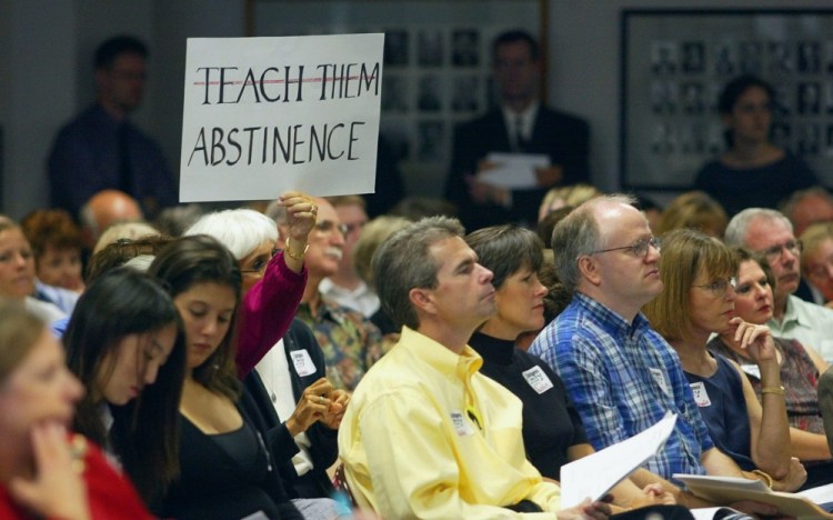 An audience member holds up a sign at a 2004 Texas State Board of Education hearing on proposed new health textbooks. A study released in February showed that 83 percent of school districts in Texas, which has one of the country's highest teen birth rates, offer no sex education or teach only abstinence.