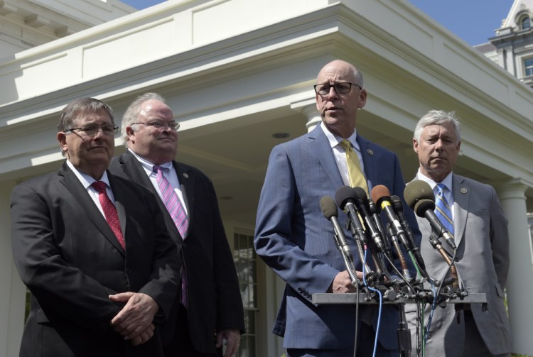 Rep. Greg Walden, R-Ore., second from right, speaks to reporters outside the White House on Wednesday after a meeting with President Trump on health care reform. From left are, Rep. Michael Burgess, R-Texas, Reps. Billy Long, R-Mo., and Rep. Fred Upton, R-Mich. Upton is proposing more financial assistance in the plan for people with pre-existing medical conditions.