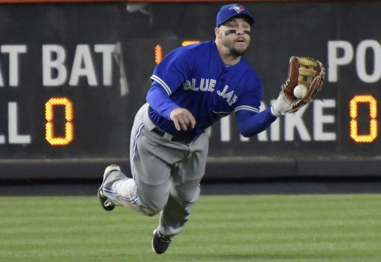 Blue Jays left fielder Steve Pearce makes a catch on a ball hit by Chase Headley of the Yankees during the fifth inning of New York's 8-6 victory over Toronto on Wednesday night at Yankee Stadium.