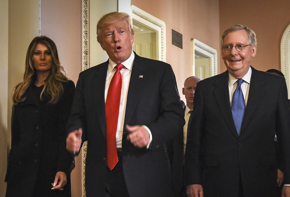 President Trump walks through the U.S. Capitol in Washington with Senate Majority Leader Mitch McConnell, R-Ky. McConnell will lead a health care bill through the Senate.