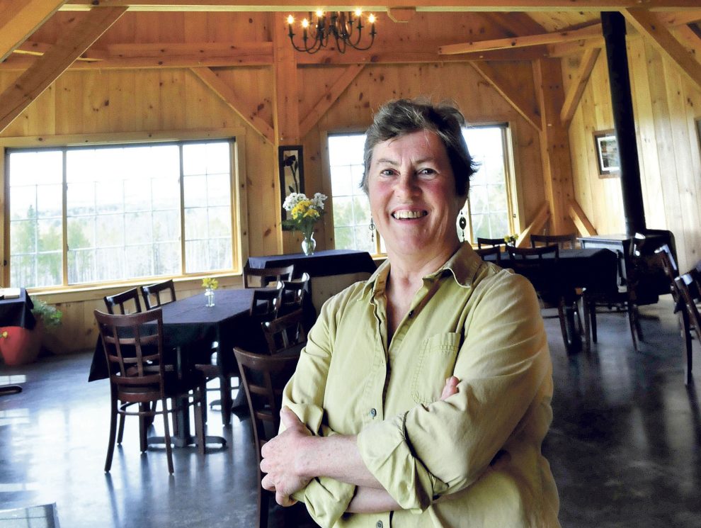 Mary Burr stands inside 122 Corson, her timber-framed restaurant in Mercer, which features locally grown and raised vegetables and meats and fancy desserts.