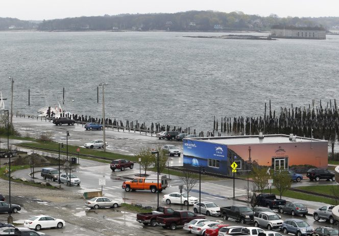 Plans call for the city-owned parking lot near the water, at top left, to become a waterfront park, and for other under-used space in the area to hold new multistory buildings that would include housing.