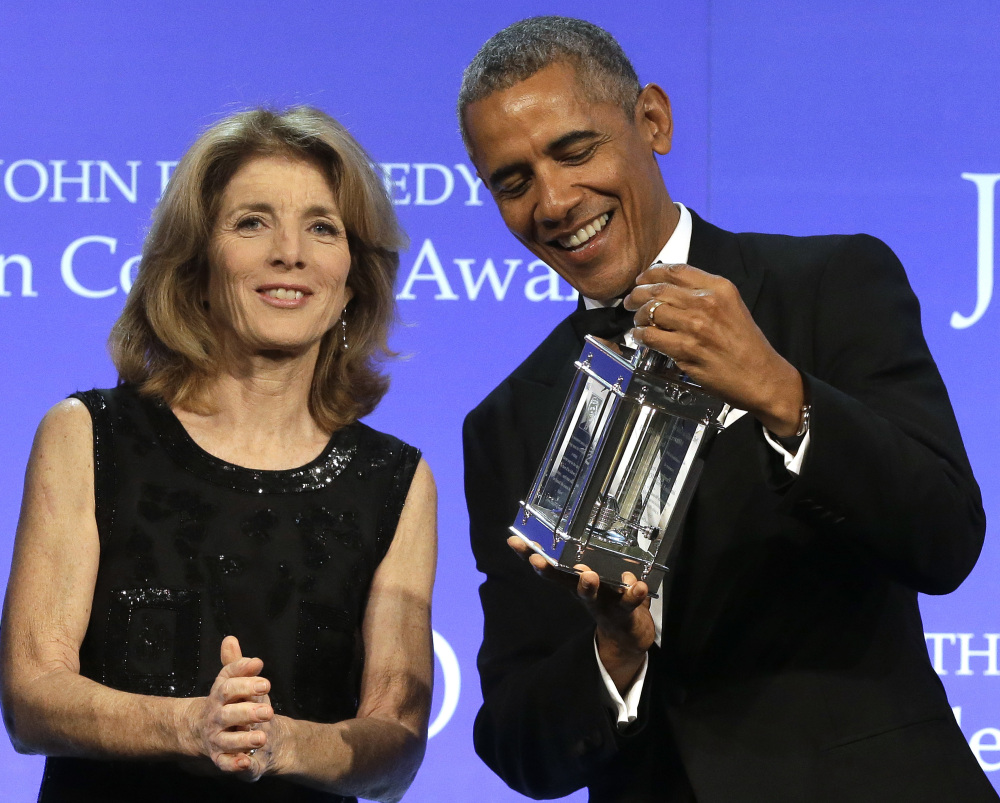 Former President Barack Obama accepts his Profile in Courage award from Caroline Kennedy in Boston on Sunday. Obama called on Congress to show courage of its own.