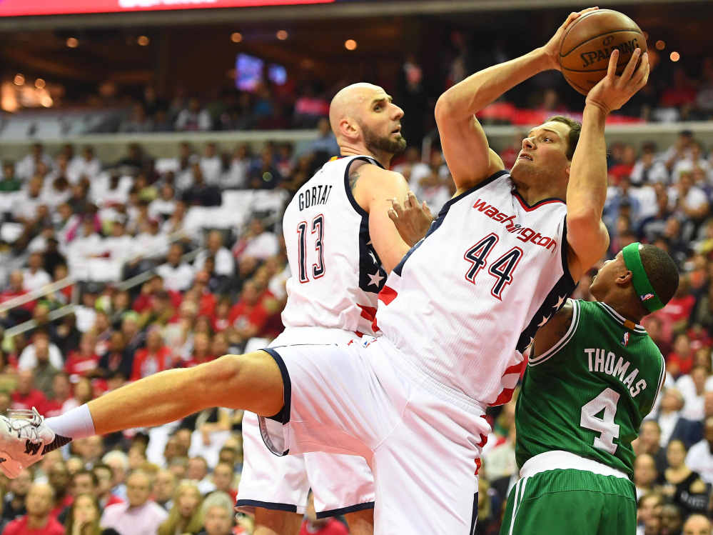 Wizards guard Bojan Bogdanovic grabs a rebound over Celtics guard Isaiah Thomas on Sunday in Washington's 121-102 win in Game 4 to even their second-round series at 2-2.