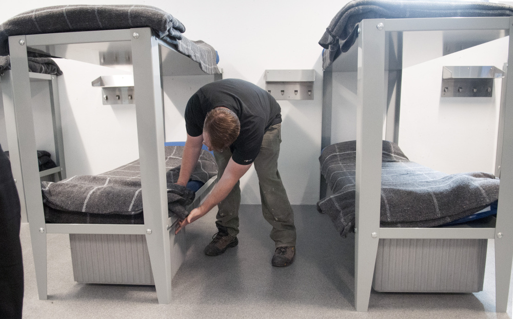 Jason Stonier, maintenance supervisor for the Kennebec County jail, puts a drawer under a bed in the new housing unit built in the jail's former indoor recreation yard.