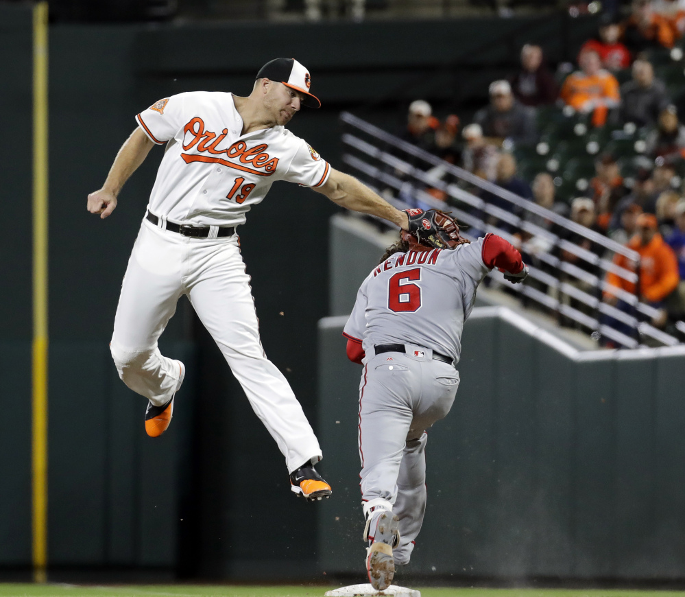 Orioles first baseman Chris Davis tags out Washington's Anthony Rendon after a wide throw on a ground ball in the sixth inning of Baltimore's 6-4 win Monday night in Baltimore. It was the Orioles' fifth straight win.