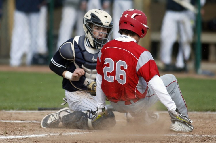 Portland catcher Cam King makes the play at home, tagging out South Portland's Gordon Whittemore in the fourth inning of Tuesday's game at South Portand.