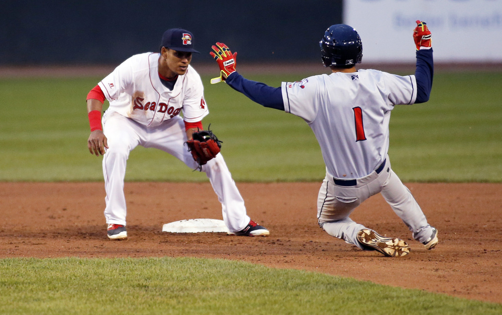 Deiner Lopez of the Portland Sea Dogs waits to apply the tag as Jio Mier of the Binghamton Rumble Ponies is caught attempting to steal second.