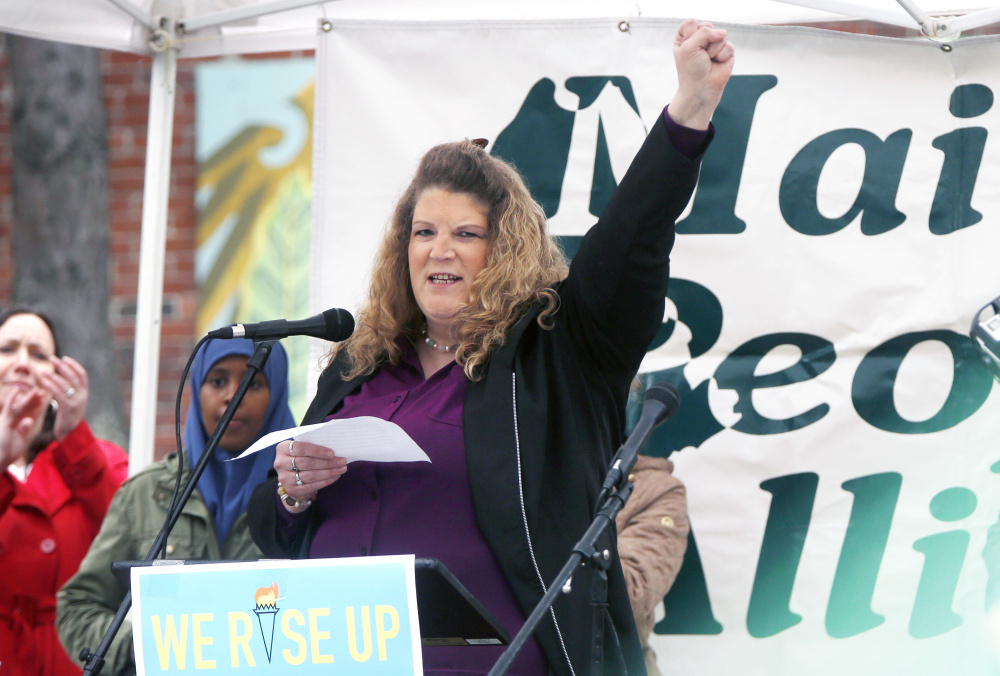 Sandra Scribner Merlim, whose husband, Otto Morales-Caballeros, was detained by U.S. Immigration and Customs Enforcement agents April 12, speaks May 1 during a rally for immigrants at Congress Square Park in Portland.