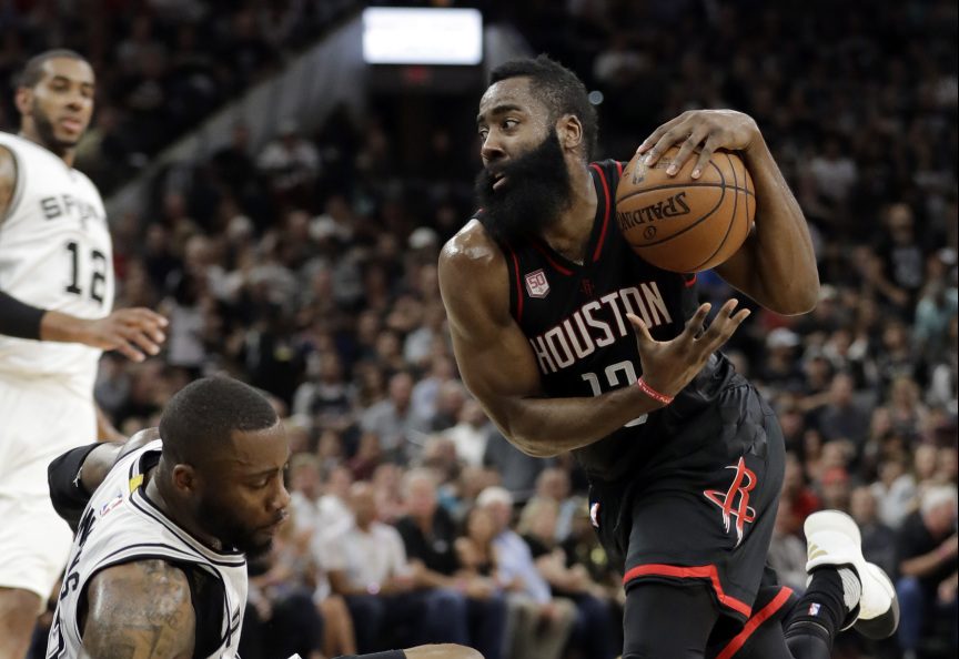 James Harden of the Houston Rockets heads to the basket as Jonathon Simmons of the San Antonio Spurs heads to the floor Tuesday during San Antonio's 110-107 overtime victory.