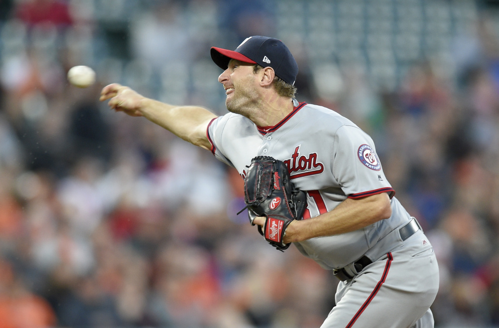 Washington's Max Scherzer delivers a pitch in the third inning Tuesday night in Baltimore. The Orioles won 5-4 in 12 innings.