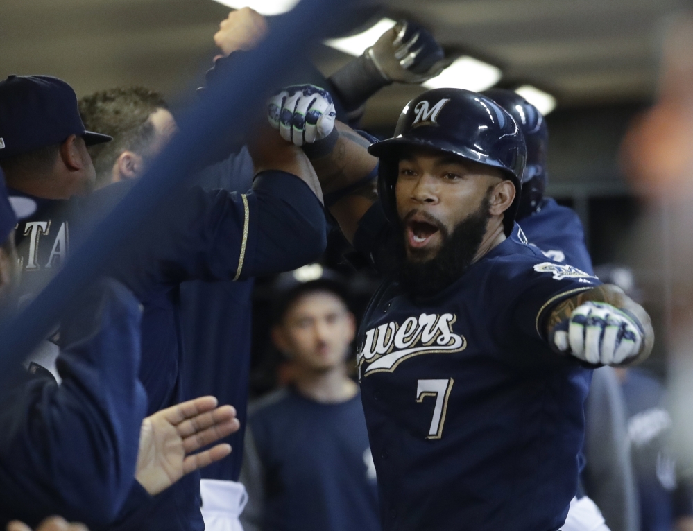 Milwaukee Brewers' Eric Thames celebrates his two-run home run with teammates during the first inning Tuesday against the Boston Red Sox.