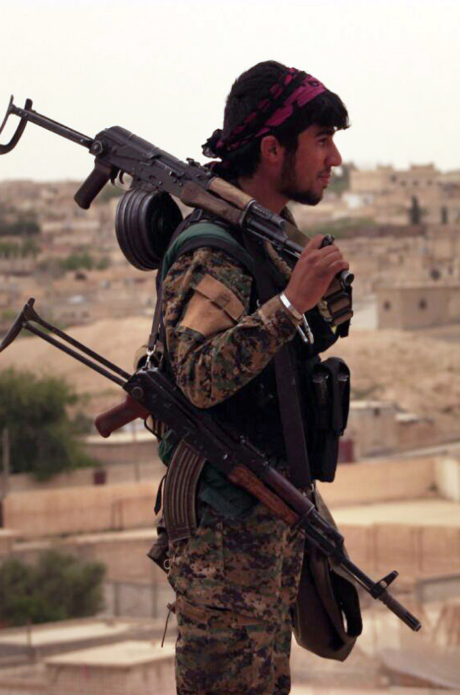 A fighter from the SDF looks toward the northern town of Tabqa, Syria, the latest IS stronghold to fall to Kurdish-led fighters.