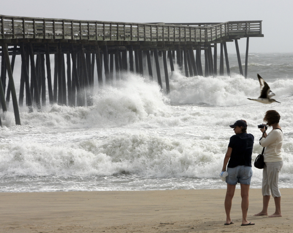 Beachgoers enjoy the view at the Virginia Beach fishing pier. Beach communities along the East Coast have been leery of plans for oil exploration.