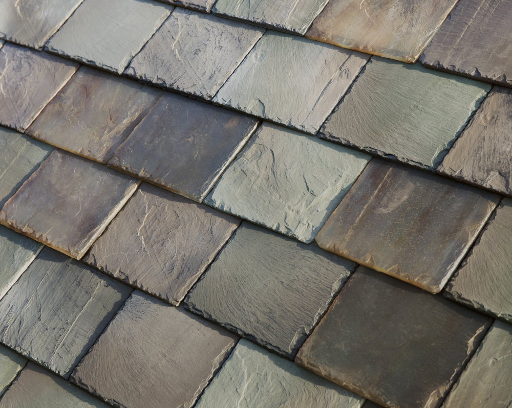 Tesla's glass solar tiles replicate slate, left, or terracotta roofing and are designed to look like a traditional roof. The tiles are guaranteed for the life of a home, much longer than the 20-year lifespan of a typical roof.