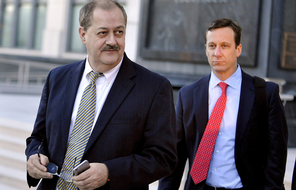 Former Massey Energy CEO Don Blankenship, left, walks out of the courthouse after the jury deliberated for a fifth full day in his trial in 2015 in Charleston, W. Va. After his release from a halfway house in Phoenix Wednesday, he must serve a year of supervised release.
