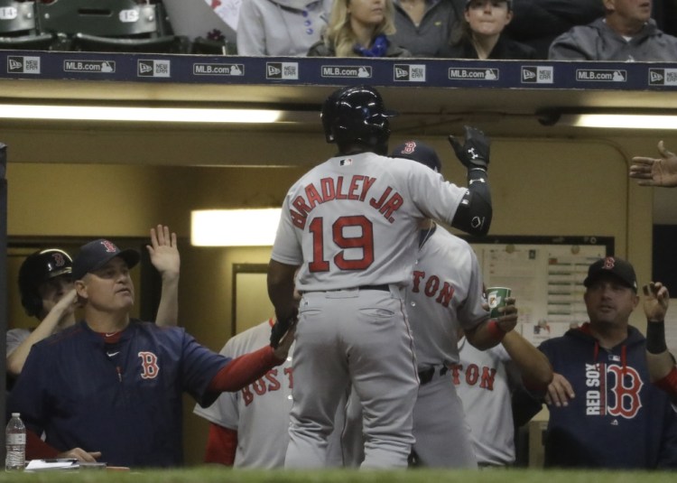 Jackie Bradley Jr. of the Red Sox is congratulated after hitting a home run during the second inning of Wednesday's game against the Brewers in Milwaukee. The game did not end before deadline.