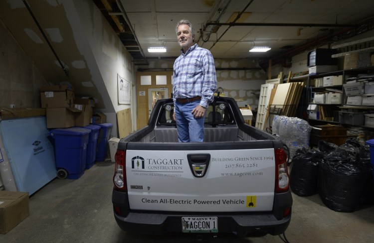 Peter Taggart of Taggart Construction in the back of one of his electric pickup trucks.