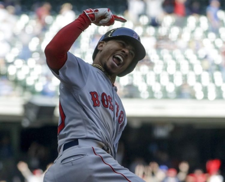 Mookie Betts reacts after hitting a three-run home run in the ninth inning of Thursday's game against the Brewers at Milwaukee.