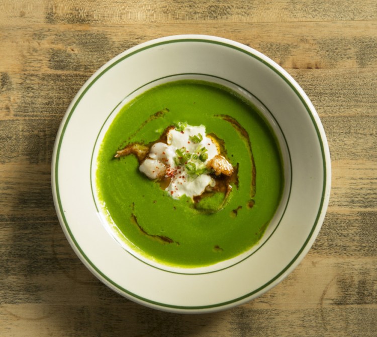 Spinach soup with rock crab, black chili and scallion.
