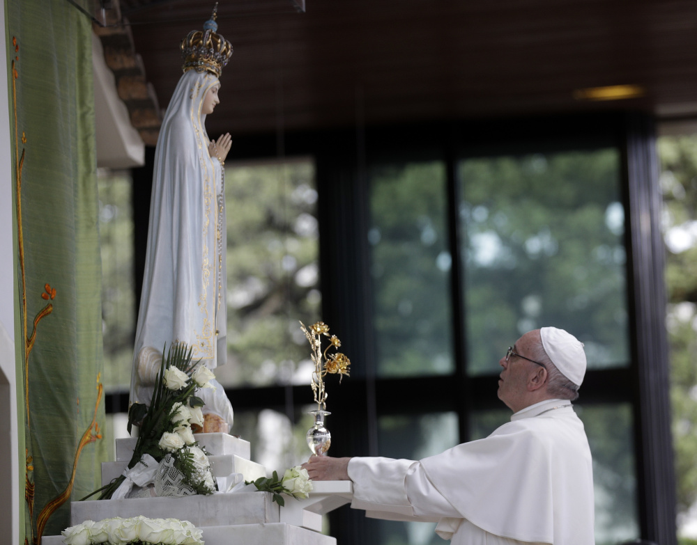 Pope Francis prays at the Sanctuary of Our Lady of Fatima on Friday. On Saturday, he will canonize two children whose visions of the Virgin Mary 100 years ago marked one of the most important events of the 20th-century Catholic Church.
