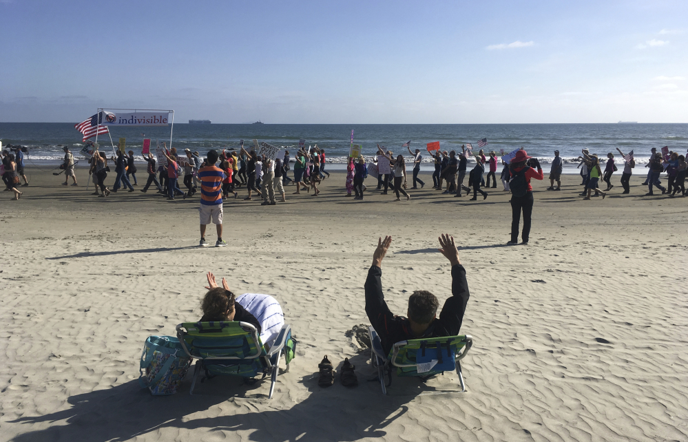 A Republican National Committee spring meeting in Coronado, Calif., last Thursday draws protesters on the beach outside the Hotel del Coronado. For some potential candidates, the Democratic presidential primary for 2020 may have already begun.