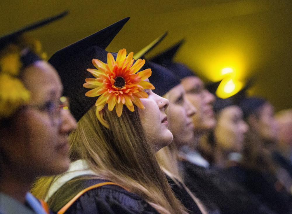 Ashley King wears a flower on her cap during Maine College of Art's commencement Saturday at the State Theatre in Portland. The graduate from Portland, Ore., received a master of arts in teaching.