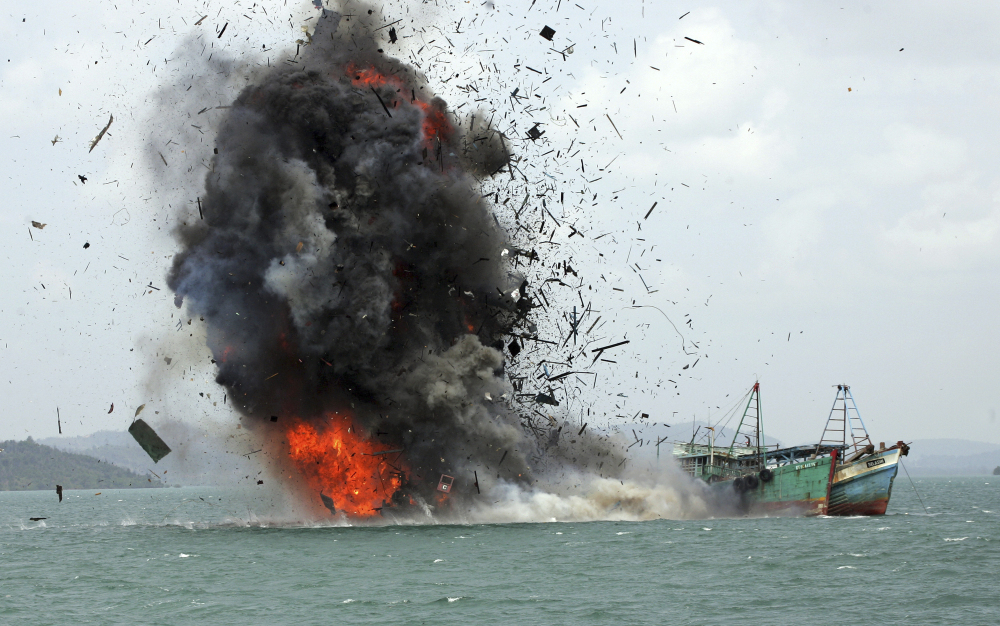 One of hundreds of foreign fishing vessels seized by the Indonesian Navy is destroyed last year off Batam Island, Indonesia. The nation's minister for maritime affairs says such efforts are essential for preserving fisheries.