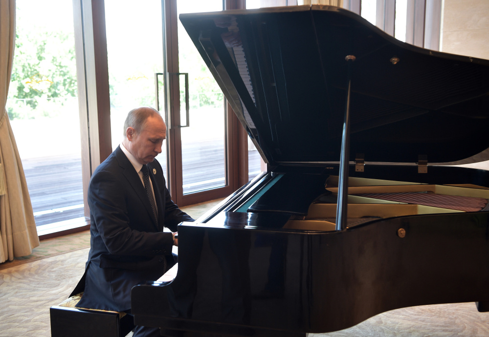 Russian President Vladimir Putin plays piano before his talks with Chinese President Xi Jinping prior to the opening ceremony of the Belt and Road Forum in Beijing on Sunday.
