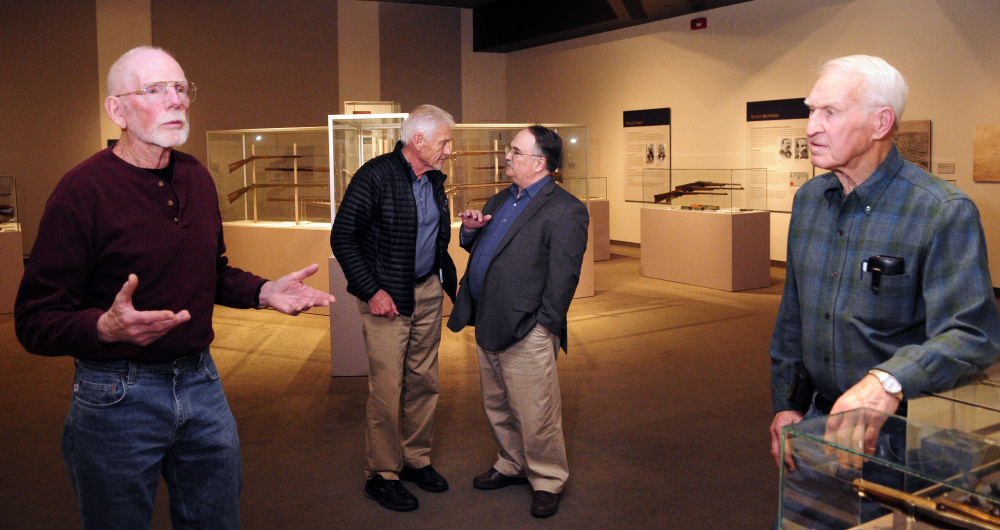 Bob Shelton, 78, left, Paul Wade, 74, Maine State Museum Director Bernard Fishman and Oscar Cronk, 86, chat in a gunsmithing display at the Maine State Museum in Augusta.