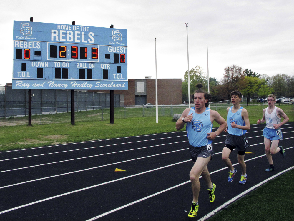 Runners pass a scoreboard bearing the "Rebel" nickname at South Burlington High School in Vermont. The school board is facing local resistance after voting to change the name.