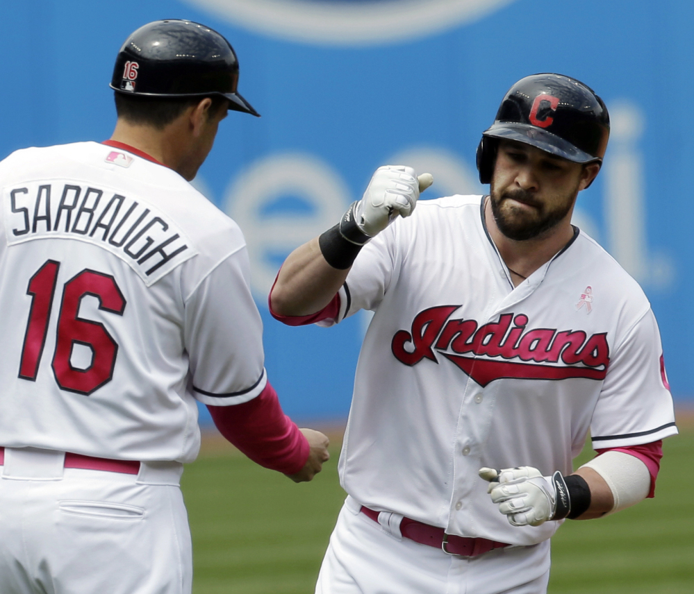 Cleveland's Jason Kipnis, right, is congratulated by third base coach Mike Sarbaugh after hitting one of his two home runs Sunday in the Indians' 8-3 win.