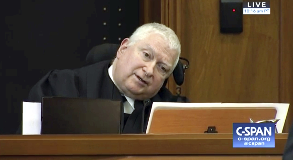 Judge Ronald Gould, a member of a 9th Circuit Court of Appeals panel, asks a questions in Seattle on Monday as the judges hear arguments over Hawaii's lawsuit challenging President Trump's travel ban.