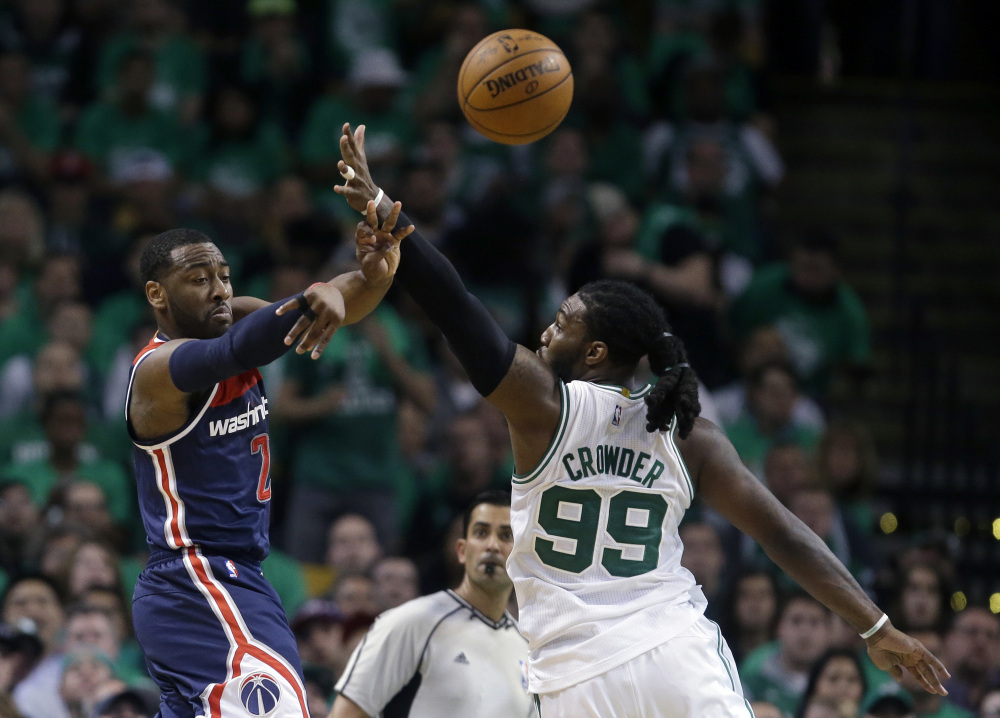 Wizards guard John Wall delivers a pass as Celtics forward Jae Crowder defends in the second quarter of Monday night's game.
