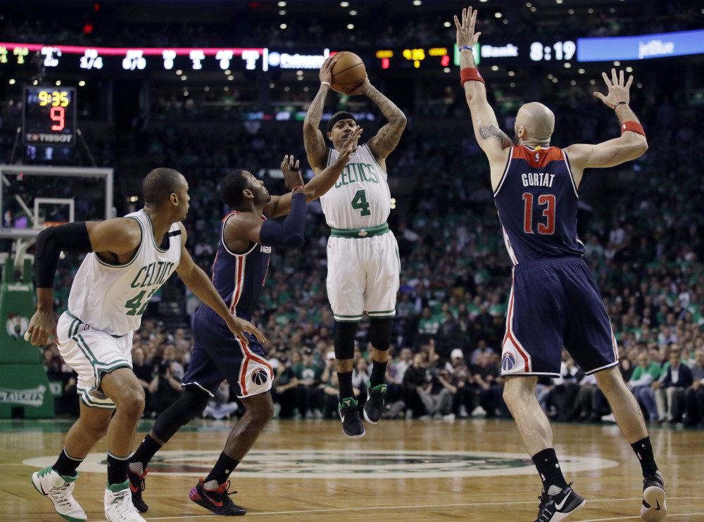 Celtics guard Isaiah Thomas shoots between Wizards guard John Wall, left, and Wizards center Marcin Gortat in the first quarter of Game 7.